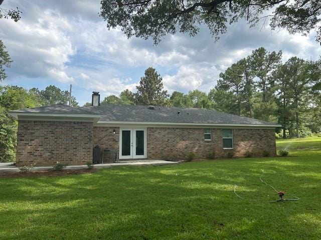13580 Laco Cooper Rd, Wilmer, AL 36587 - rear view of house with french doors, a yard, brick siding, and a chimney