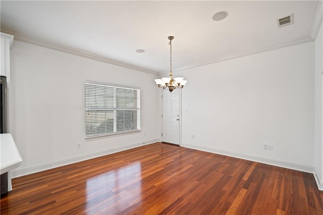 404 Savannah Ln, Foley, AL 36535 - spare room featuring a chandelier, dark wood-type flooring, visible vents, baseboards, and ornamental molding