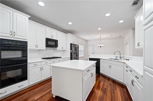 404 Savannah Ln, Foley, AL 36535 - kitchen with light countertops, a sink, a peninsula, and black appliances