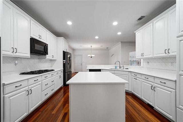 404 Savannah Ln, Foley, AL 36535 - kitchen with a kitchen island, decorative light fixtures, light countertops, black appliances, and a sink
