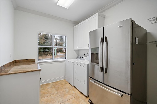 404 Savannah Ln, Foley, AL 36535 - washroom featuring ornamental molding, cabinet space, washer and clothes dryer, and light tile patterned floors