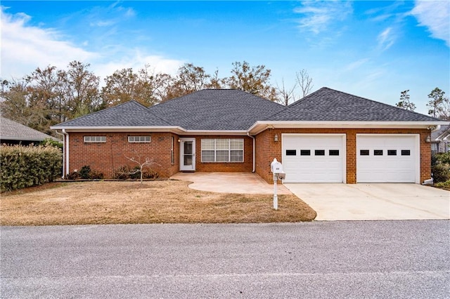 404 Savannah Ln, Foley, AL 36535 - ranch-style house with concrete driveway, brick siding, roof with shingles, and an attached garage