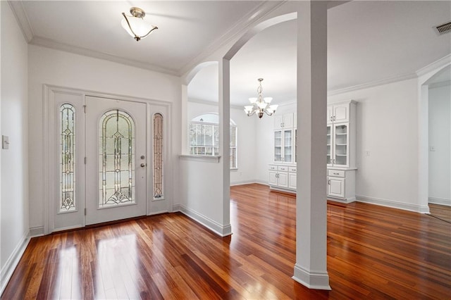 404 Savannah Ln, Foley, AL 36535 - entryway featuring dark wood-style floors, ornamental molding, arched walkways, and baseboards