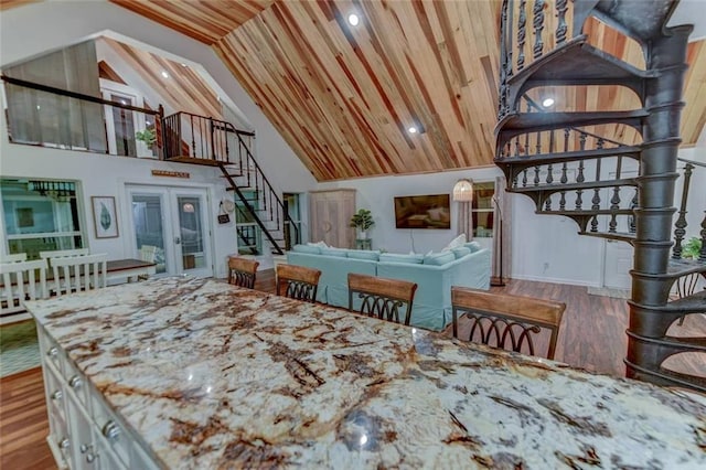 dining space featuring french doors, wood-type flooring, high vaulted ceiling, and wooden ceiling