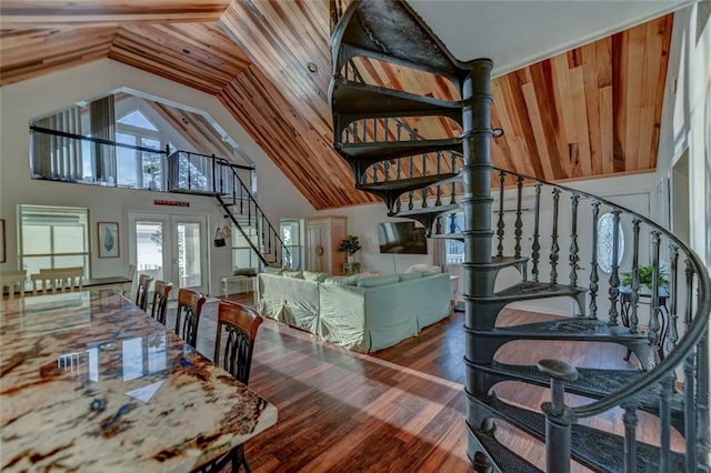 dining space featuring hardwood / wood-style floors, high vaulted ceiling, and french doors