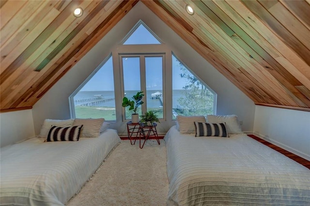 bedroom featuring multiple windows, vaulted ceiling, and a water view