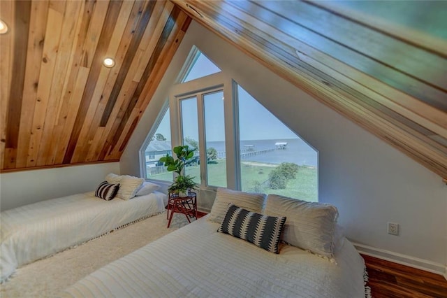 bedroom with a water view, dark hardwood / wood-style flooring, and vaulted ceiling