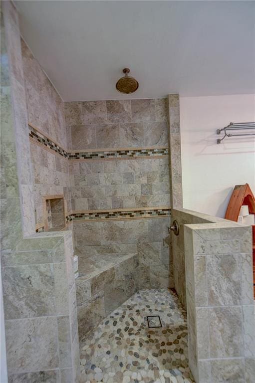 bathroom with tiled shower