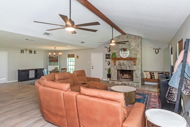 11525 Lott Rd, Chunchula, AL 36521 - living room featuring a ceiling fan, a chandelier, light wood finished floors, and a fireplace
