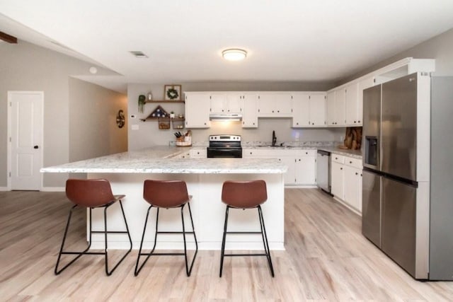 11525 Lott Rd, Chunchula, AL 36521 - kitchen featuring stainless steel appliances, white cabinets, light wood finished floors, and under cabinet range hood