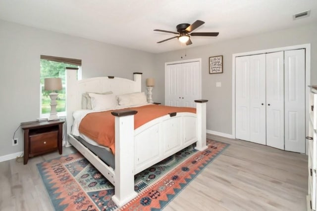 11525 Lott Rd, Chunchula, AL 36521 - bedroom with two closets, light wood-type flooring, and a ceiling fan