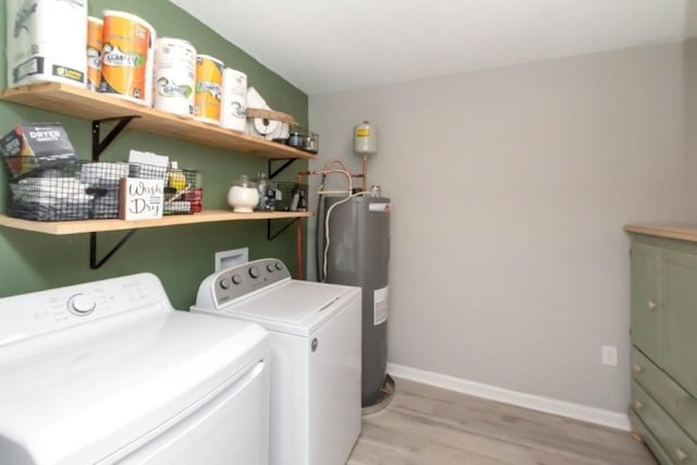 11525 Lott Rd, Chunchula, AL 36521 - laundry room featuring electric water heater, independent washer and dryer, light wood finished floors, and cabinet space