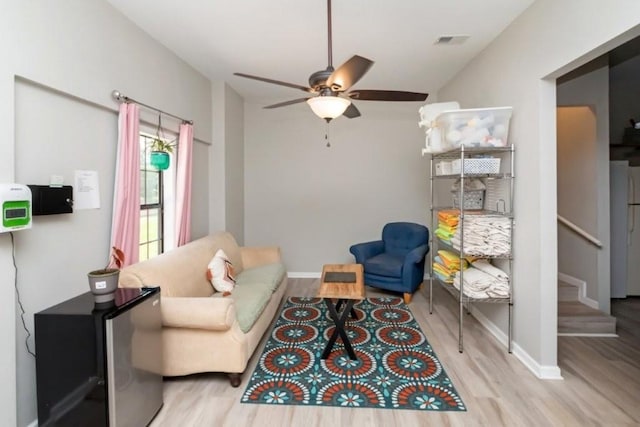 11525 Lott Rd, Chunchula, AL 36521 - living area with wood finished floors, ceiling fan, and stairs