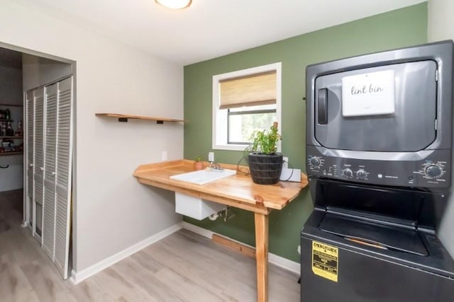 11525 Lott Rd, Chunchula, AL 36521 - laundry room featuring stacked washer and clothes dryer and light wood-style flooring