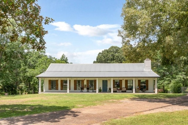 11525 Lott Rd, Chunchula, AL 36521 - rear view of house with a porch, a yard, a chimney, and a metal roof