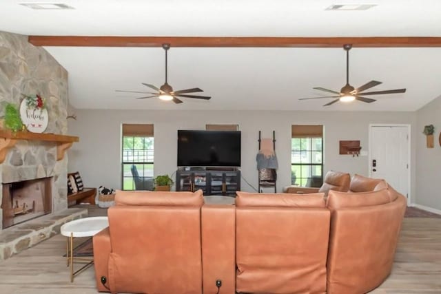 11525 Lott Rd, Chunchula, AL 36521 - living area featuring a ceiling fan, plenty of natural light, light wood-style floors, and a stone fireplace