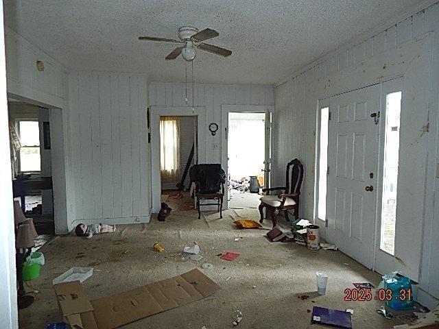 unfurnished living room featuring a textured ceiling and a ceiling fan