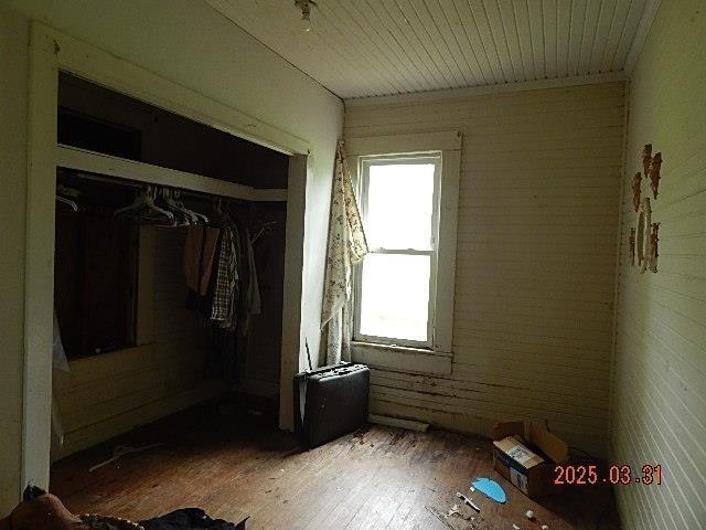 interior space with a closet and brick wall