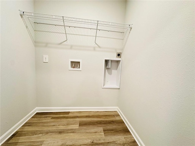 washroom featuring electric dryer hookup, washer hookup, and hardwood / wood-style flooring