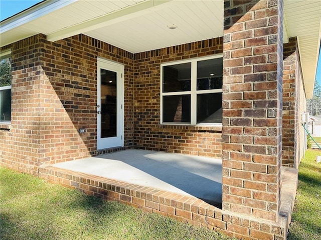 view of exterior entry featuring a patio