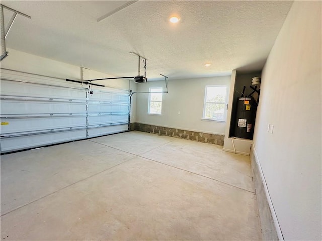 garage featuring electric water heater and a garage door opener