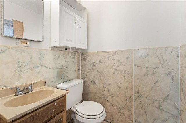 672 Burden St, Mobile, AL 36607 - half bath with tile walls, toilet, vanity, and wainscoting