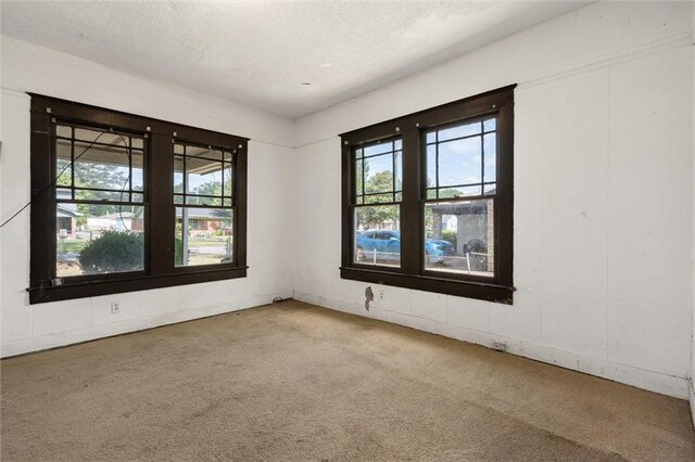 672 Burden St, Mobile, AL 36607 - carpeted empty room featuring healthy amount of natural light and a textured ceiling
