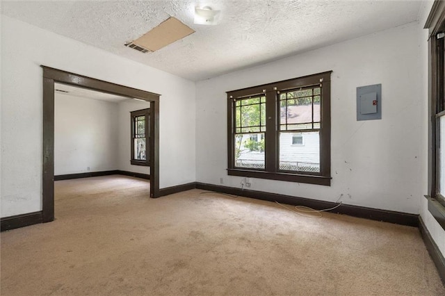 672 Burden St, Mobile, AL 36607 - carpeted empty room with healthy amount of natural light, a textured ceiling, electric panel, and baseboards