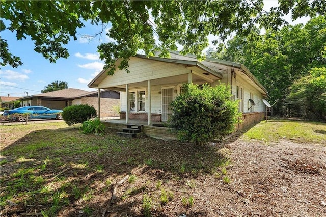 672 Burden St, Mobile, AL 36607 - bungalow with a porch and brick siding