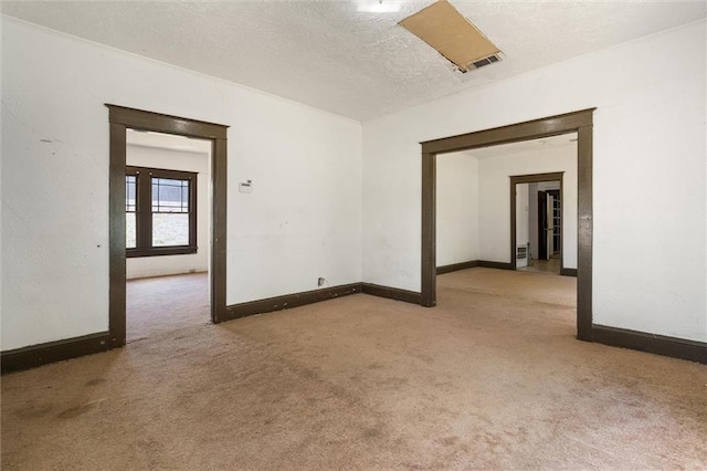 672 Burden St, Mobile, AL 36607 - empty room featuring carpet flooring, baseboards, and a textured ceiling