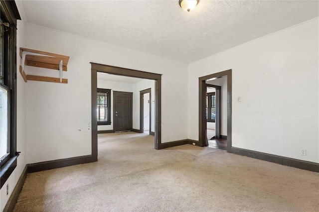 672 Burden St, Mobile, AL 36607 - empty room with light colored carpet, baseboards, and a textured ceiling