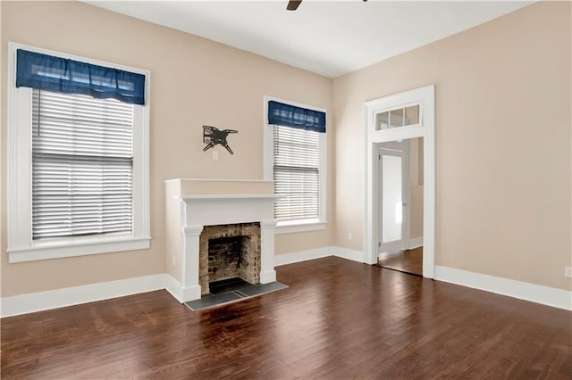 unfurnished living room featuring dark hardwood / wood-style floors and ceiling fan