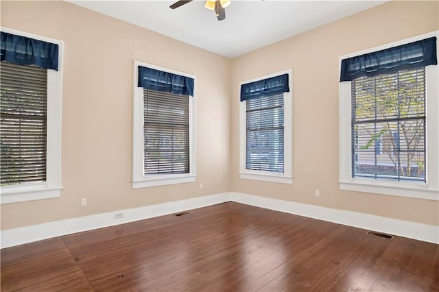 unfurnished room with hardwood / wood-style floors and ceiling fan