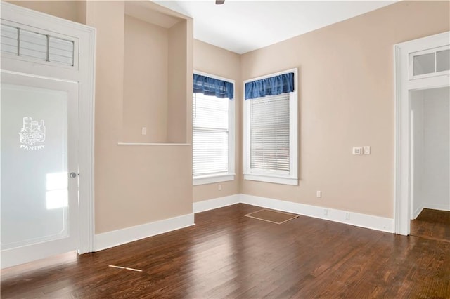 unfurnished room with dark hardwood / wood-style flooring