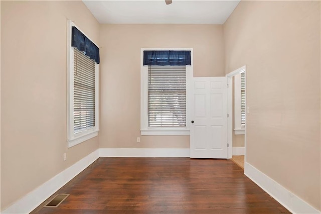 unfurnished room featuring dark wood-type flooring