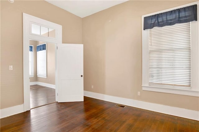 spare room featuring hardwood / wood-style flooring