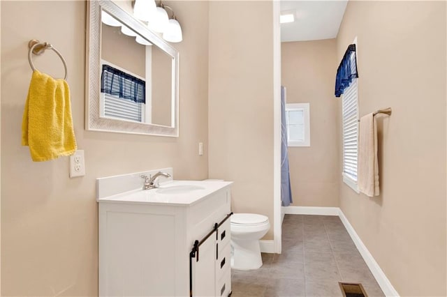 bathroom featuring vanity, toilet, and tile patterned floors