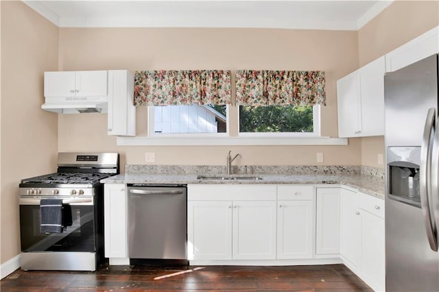 kitchen with white cabinets, light stone counters, appliances with stainless steel finishes, dark hardwood / wood-style floors, and sink