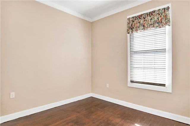 spare room with hardwood / wood-style flooring and ornamental molding