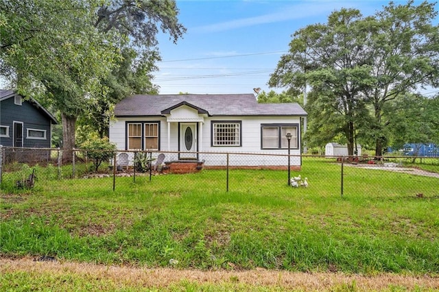 view of front of home with a storage shed and a front yard