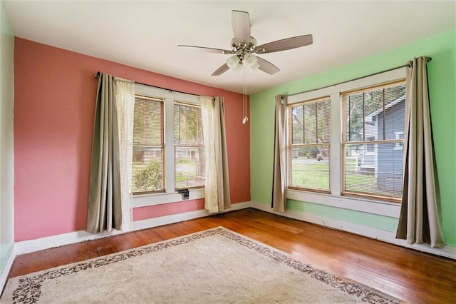 empty room with wood-type flooring and ceiling fan