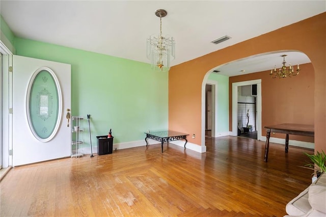 foyer featuring hardwood / wood-style flooring and a notable chandelier