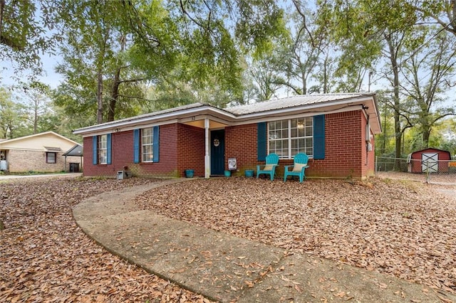 ranch-style home featuring a storage shed