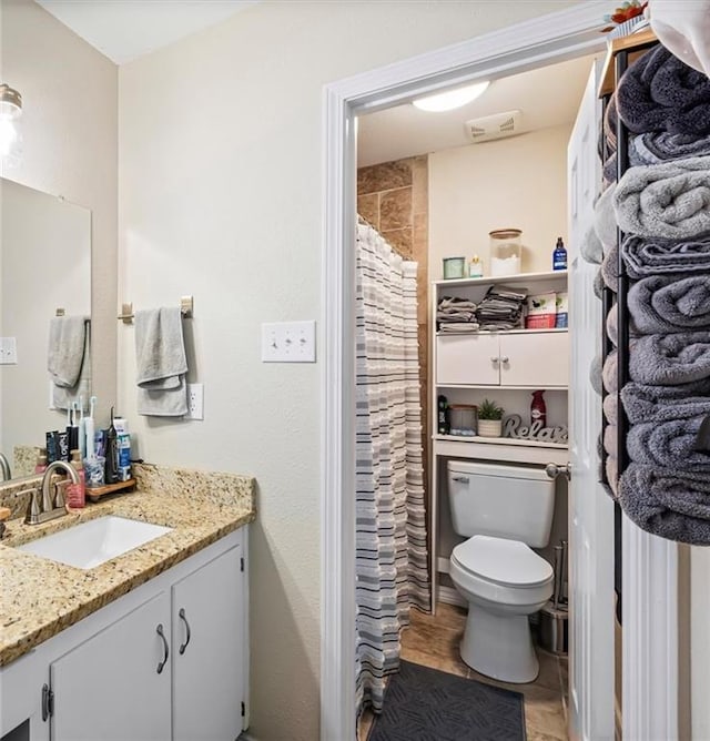 bathroom featuring vanity and toilet