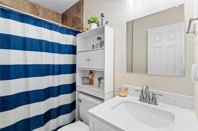 bathroom featuring vanity, a shower with shower curtain, and toilet