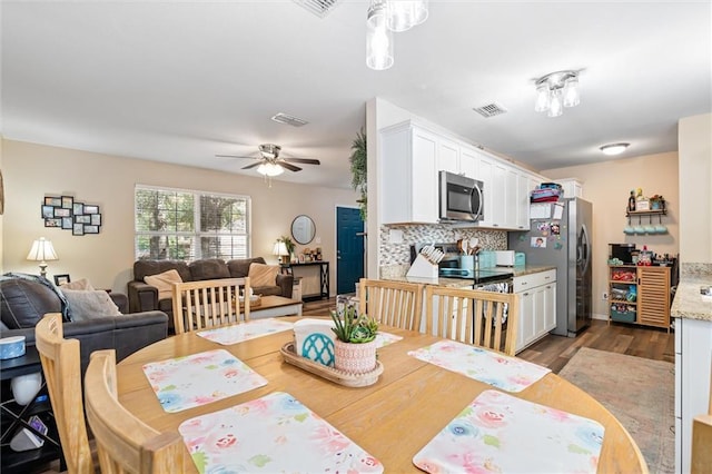 dining space featuring dark hardwood / wood-style flooring and ceiling fan