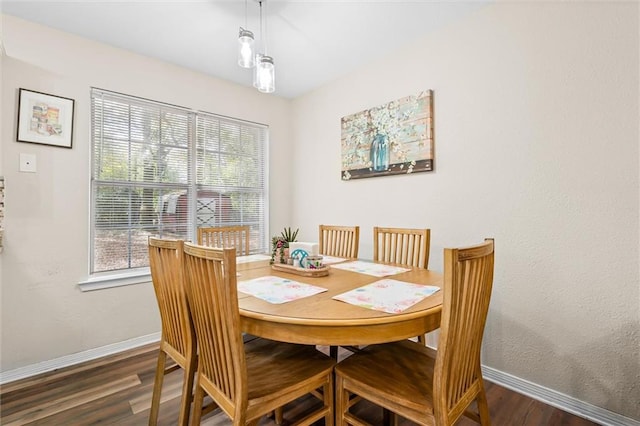 dining space with dark hardwood / wood-style flooring