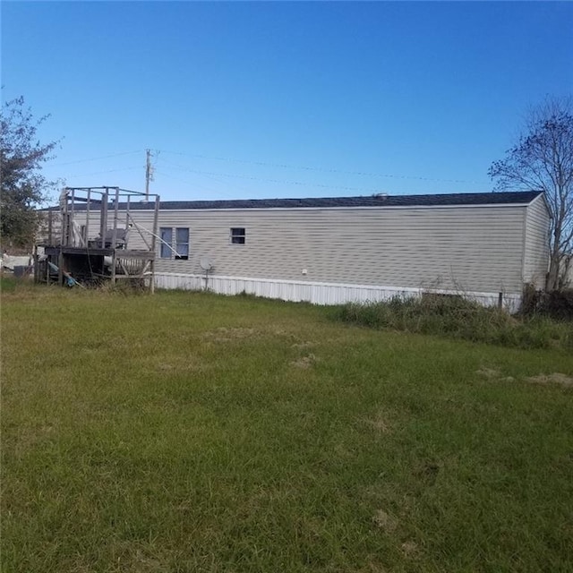 view of side of home with a lawn