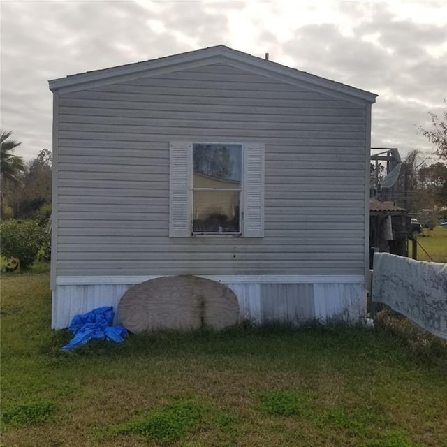 view of home's exterior with a yard