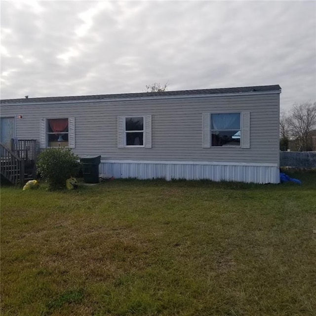 view of property exterior featuring a lawn